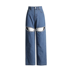 Dettaglio di jeans a vita alta a gamba larga con ritagli impreziositi da strass sulle cosce