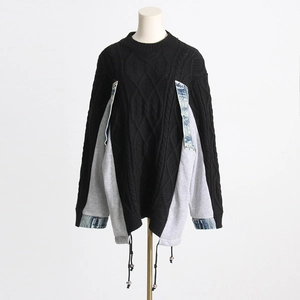 Detail of cable knit texture with denim patchwork and adjustable drawstring hem