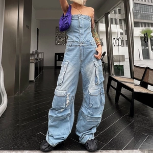Detail of light blue washed denim jumpsuit with multi-pocket design and strapless top
