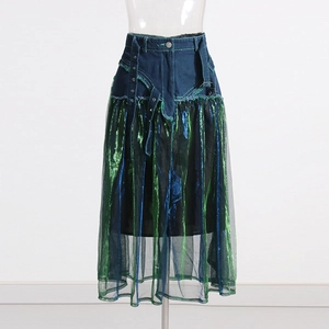 Detail view of denim waist and gradient metallic mesh stitching on A-line midi skirt