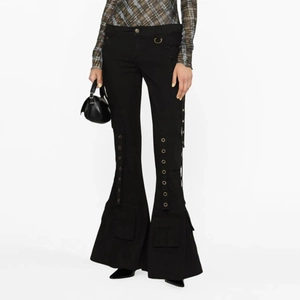 Detail view of black flare cargo trousers with metal eyelets and large utility pockets