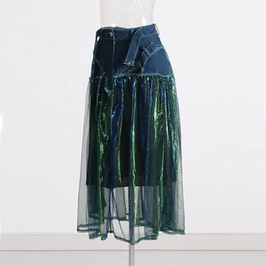 Detail of high-waisted denim skirt with metallic tulle patchwork and buckle