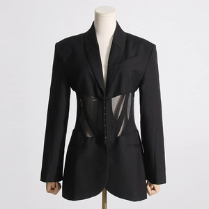 Detail view of fishbone corset waist with sheer mesh stitching on black blazer