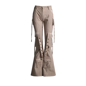Detail of khaki cargo flare pants with decorative metal eyelets and hanging ribbons