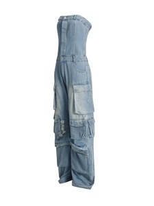 Detail view of light blue denim cargo jumpsuit with strapless neck and side pockets