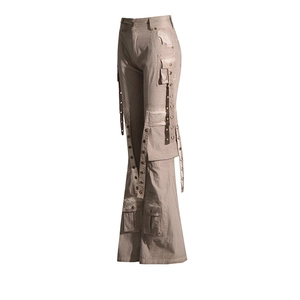 Detail of khaki flare cargo pants with multiple pockets and ribbons with metal eyelets