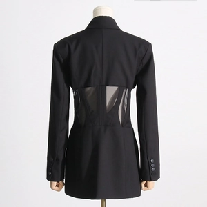 Back view of black blazer showing sheer mesh patchwork and boning corset structure