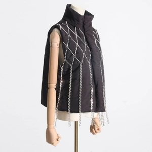 Close-up of black quilted vest featuring stand collar and sparkling silver rhinestone fringes
