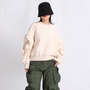 Detail of beige crewneck sweatshirt featuring unique 3D bow pleated sleeve ornaments