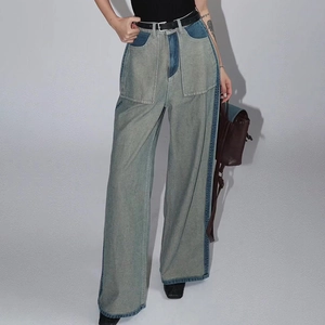 Detailed view of high-waisted wide leg jeans with contrast side stitching and large pockets