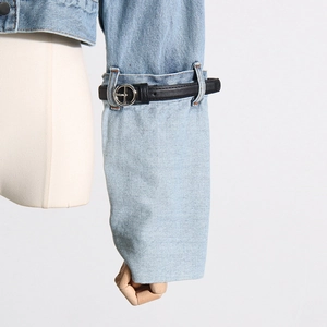 Detailed close-up of light blue denim sleeve featuring a black belt and silver metal buckle
