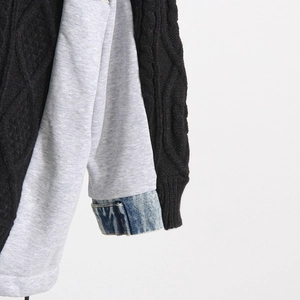 Detail showing the mixed material texture of knit, cotton, and denim patchwork sleeve