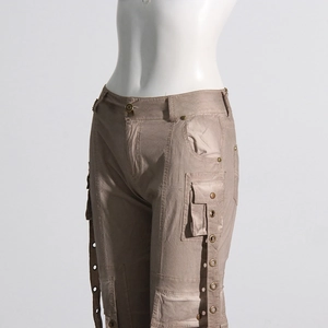 Detail of khaki cargo trousers featuring flap pockets and ribbons with metal eyelets
