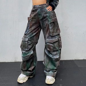 Detail shot of vintage high-waist cargo pants with multiple utility pockets and acid-wash finish