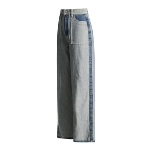 Detail view of high-waisted wide-leg jeans with contrast stitching and paneling