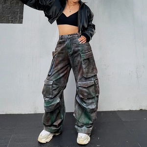 Detail view of vintage green multi-pocket cargo pants with graffiti textures and wash style