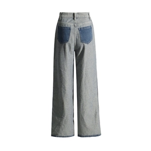 Detail view of high waist wide leg denim trousers with dark blue contrast back pockets