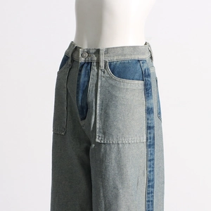 Detailed side view of high-waisted wide-leg jeans with unique blue contrast stitching