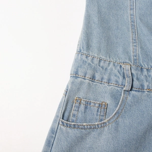 Detail of light blue denim waist with belt loops and stitching on cargo jumpsuit