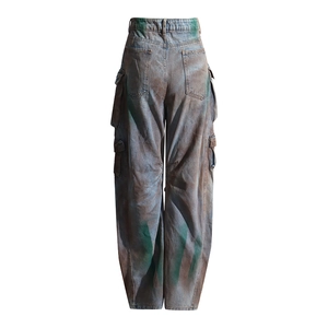 Rear view of distressed baggy cargo jeans with multi-pocket and green graffiti paint