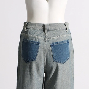 Detail of high-waist straight-leg jeans with contrasting dark blue back pockets