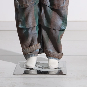 Detailed view of cargo denim pants featuring vintage wash and adjustable ankle straps