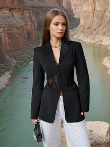 Slim fit black blazer with mesh corset waist and white trousers for a French chic look
