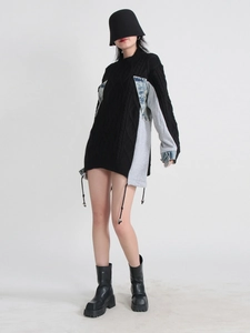 Women's oversized knit sweater with denim patchwork sleeves in a relaxed street style