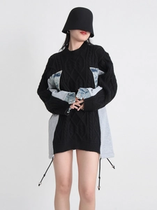 Oversized black cable knit sweater with denim patchwork and adjustable drawstring hem