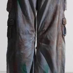 Detail of vintage cargo jeans with acid wash finish and multi-pocket design features