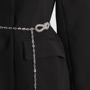 Close-up of elegant silver belt with rhinestone infinity buckle on a black blazer