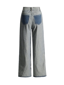 Back view of vintage high-waisted wide-leg jeans with contrast dark blue rear pockets