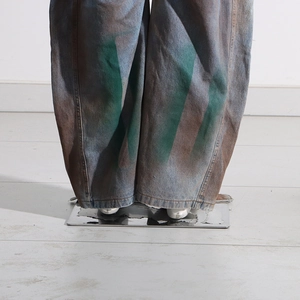 Detailed macro view of baggy graffiti cargo jeans with vintage color dye and thick cotton texture