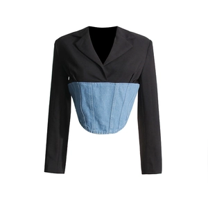 Detailed shot of the corset-style denim waist stitching on a black blazer jacket