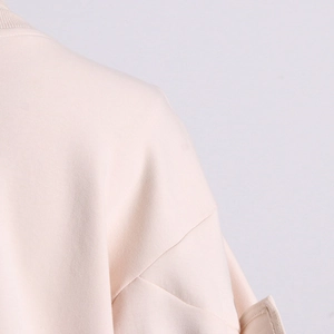 Detail shot of light pink sweatshirt fabric with fine texture and precise stitching