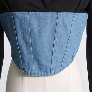Detailed view of blue denim corset top with tailored panels and tonal topstitching