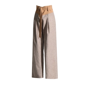 Detail of high-waisted wide-leg pants with color-block belt and textured fabric