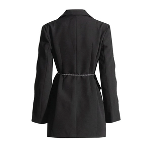 Detail of a black blazer back featuring a silver chain belt and hollow sleeve design