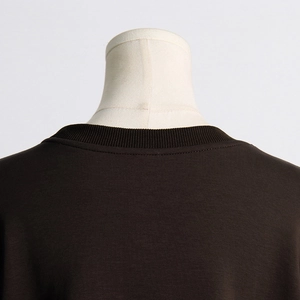 Detail of coffee brown sweatshirt ribbed crew neck and neat stitching on shoulder
