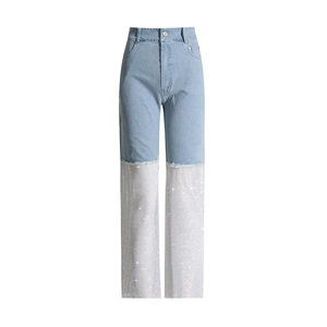 Detail showing high-waist denim pants with silver rhinestone stitching and frayed edges
