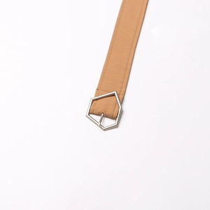 Detail of khaki fabric belt featuring a silver pentagonal geometric metal buckle