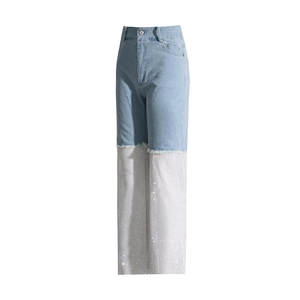 Detail of high-waist straight jeans featuring sparkling rhinestone fishnet splicing hem