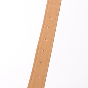 Close-up of khaki canvas belt featuring reinforced metal eyelets and detailed stitching