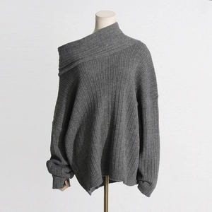 Detail of dark grey ribbed knit sweater with unique asymmetrical off-shoulder collar design