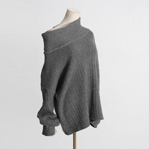 Detail view of the gray off-shoulder knit sweater showing its vertical ribbed texture
