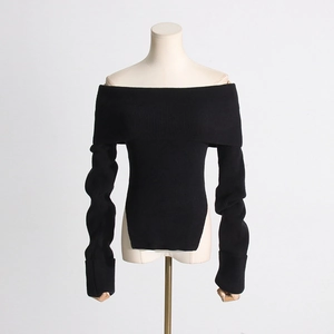 Detail eines schulterfreien schwarzen Rippstrickpullovers mit Seitenschlitzen und schmaler Passform