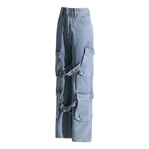 Detailed view of light blue cargo jeans with multiple utility pockets and decorative straps