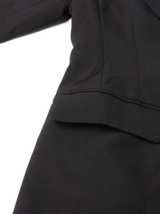 Macro shot of pocket detail and premium stitching on a black cutout blazer for women