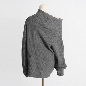 Detail of grey ribbed knit sweater with off-the-shoulder neckline and slouchy long sleeves
