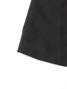 Detailed close-up showing the fine woven texture and premium stitching of the black blazer